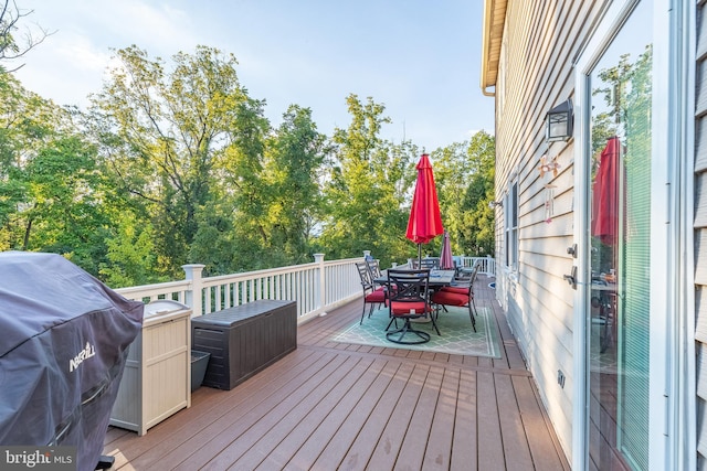 wooden deck featuring a grill