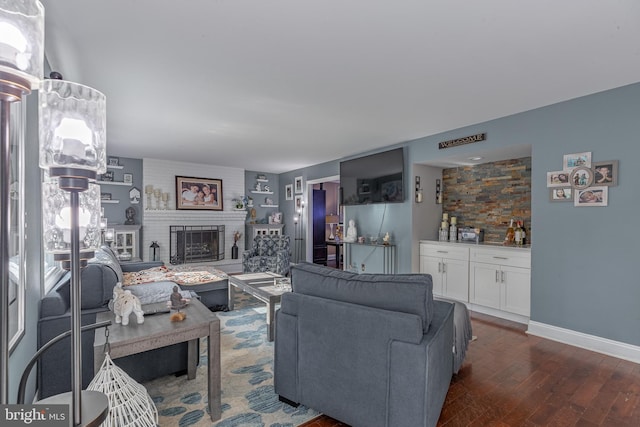 living room featuring a fireplace and dark wood-type flooring