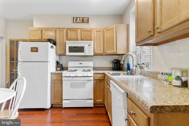 kitchen with dark hardwood / wood-style flooring, tasteful backsplash, white appliances, sink, and light brown cabinets