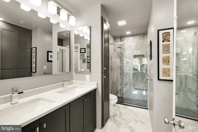 bathroom with a shower with door, vanity, and toilet