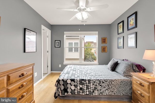 bedroom with ceiling fan and light wood-type flooring