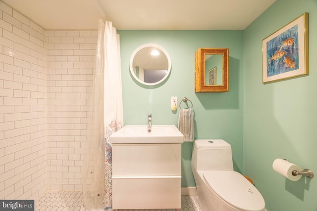 bathroom featuring tile patterned floors, a shower with curtain, toilet, and sink