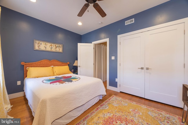 bedroom featuring ceiling fan, wood-type flooring, and a closet