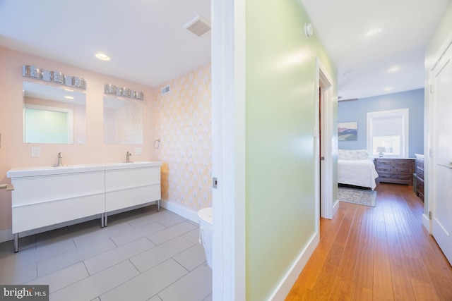 bathroom featuring hardwood / wood-style floors, vanity, and toilet