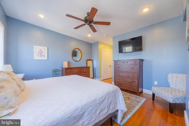 bedroom featuring ceiling fan, a closet, and hardwood / wood-style flooring