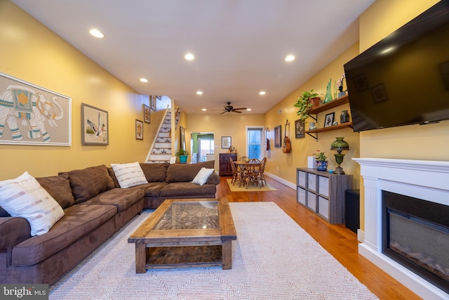 living room with wood-type flooring and ceiling fan