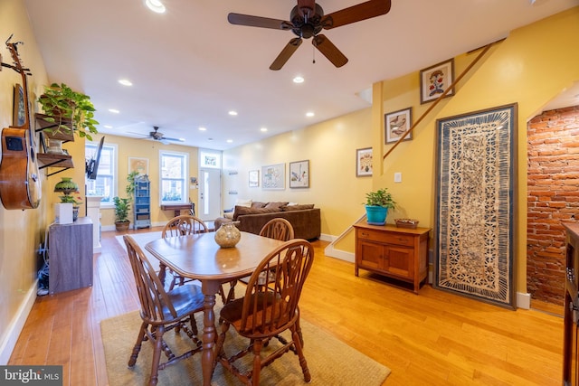 dining area with light hardwood / wood-style floors and ceiling fan