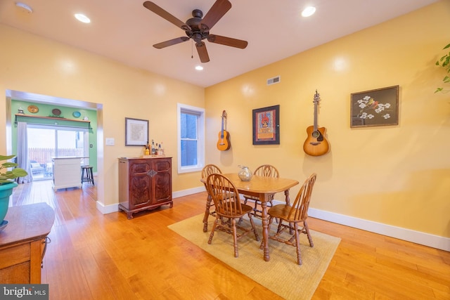 dining area featuring light wood-type flooring and ceiling fan