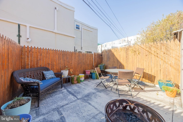 view of patio / terrace featuring an outdoor living space with a fire pit