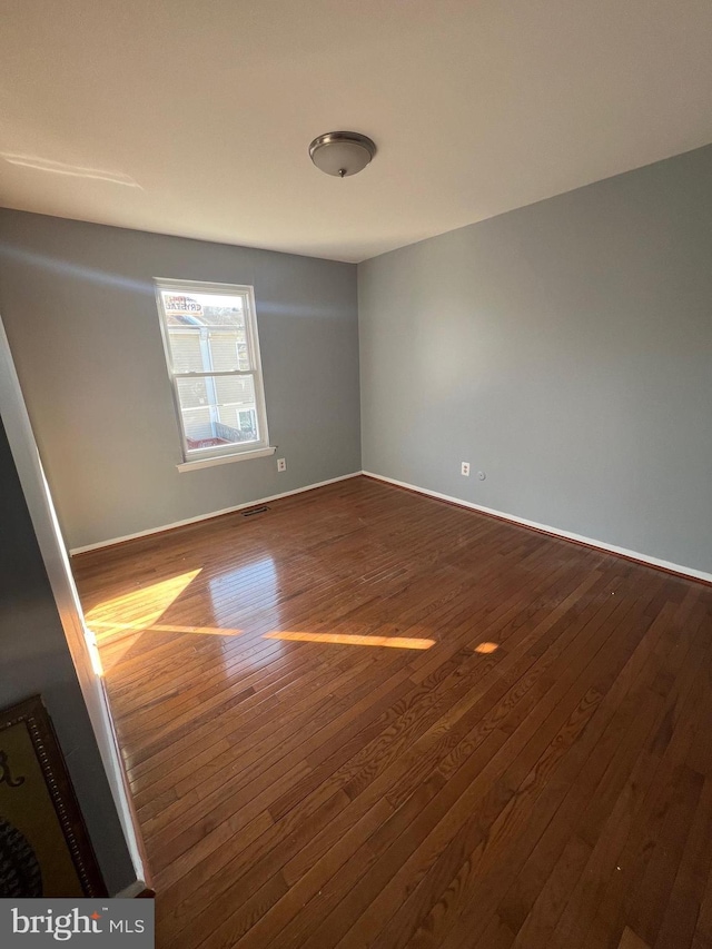 unfurnished room featuring wood-type flooring