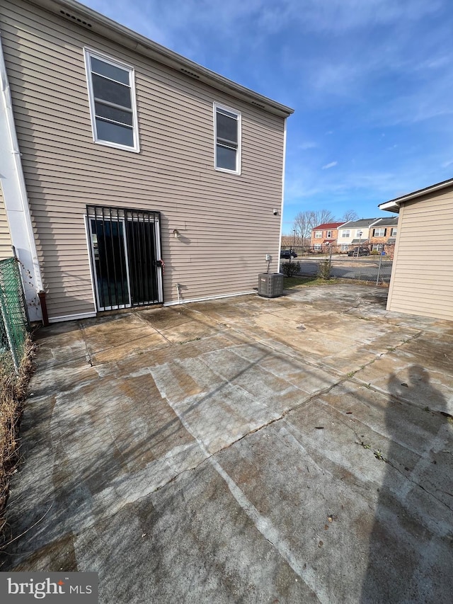 rear view of house with cooling unit and a patio