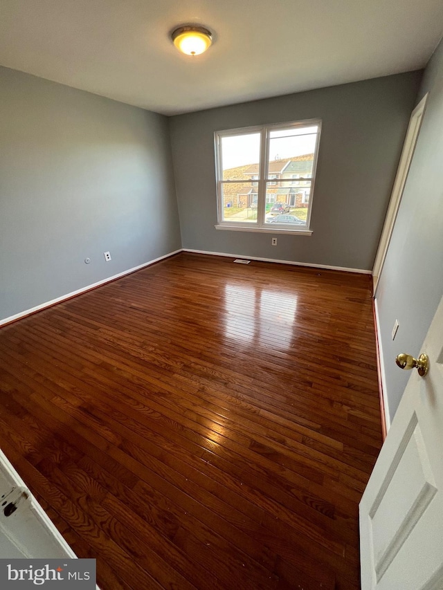 unfurnished room with dark hardwood / wood-style floors