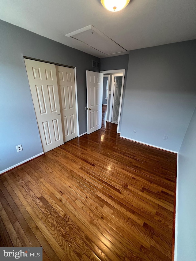 unfurnished bedroom with hardwood / wood-style flooring