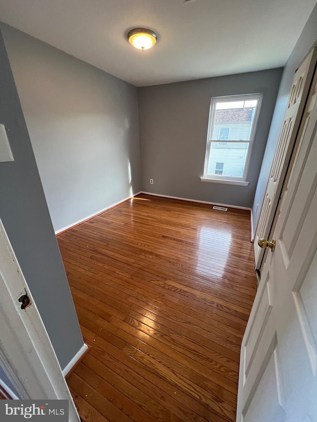 unfurnished room featuring hardwood / wood-style floors