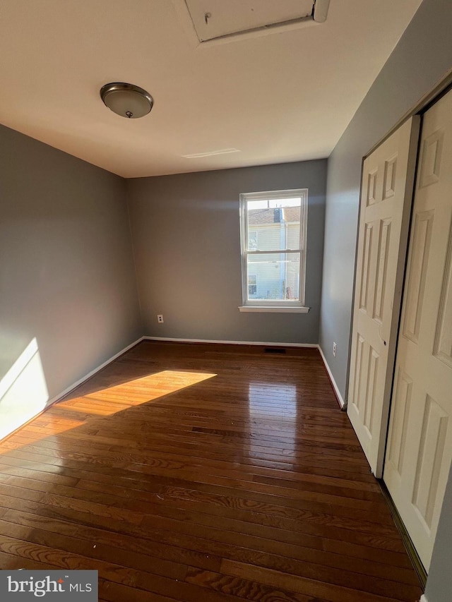 unfurnished bedroom featuring dark wood-type flooring