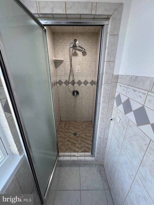 bathroom with tile patterned floors and an enclosed shower