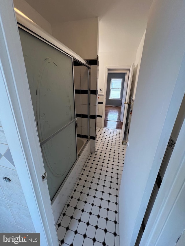 bathroom with tile patterned floors and combined bath / shower with glass door