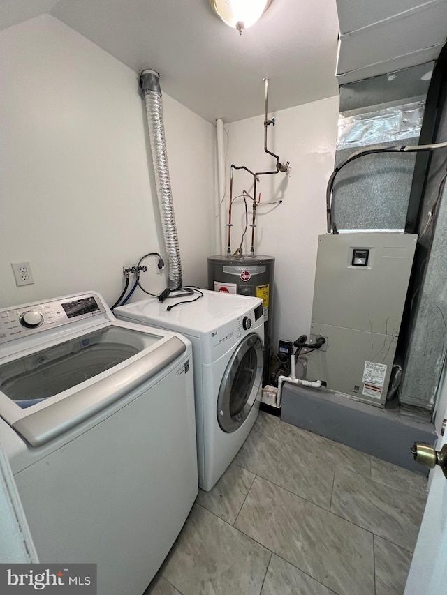 laundry room featuring washer and clothes dryer and water heater