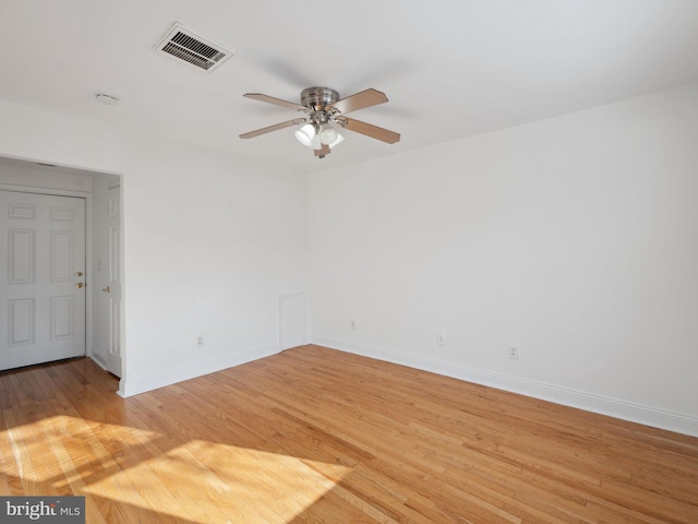 empty room with ceiling fan and light hardwood / wood-style flooring