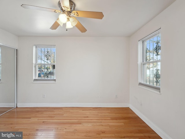 empty room featuring light hardwood / wood-style flooring, plenty of natural light, and ceiling fan