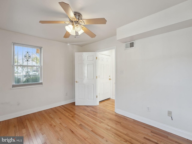 spare room featuring light hardwood / wood-style flooring and ceiling fan