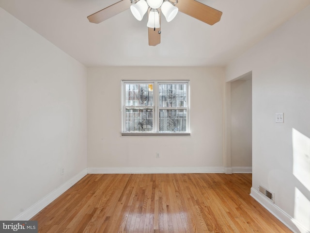 spare room featuring light hardwood / wood-style flooring and ceiling fan