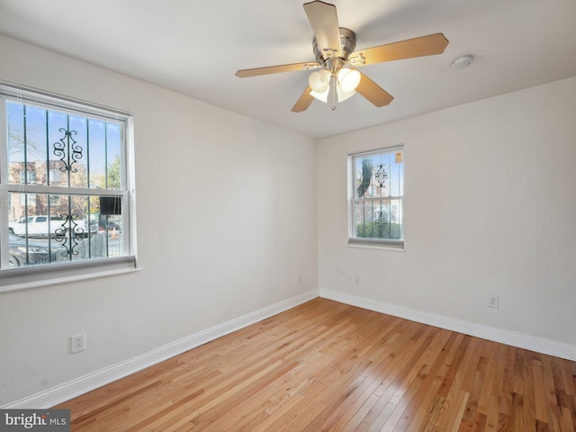 empty room featuring ceiling fan and light wood-type flooring