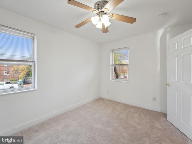 carpeted empty room featuring ceiling fan