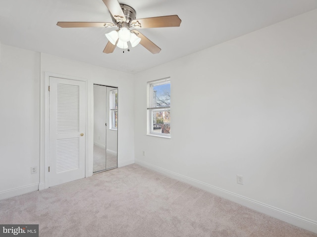 unfurnished bedroom featuring ceiling fan and light colored carpet