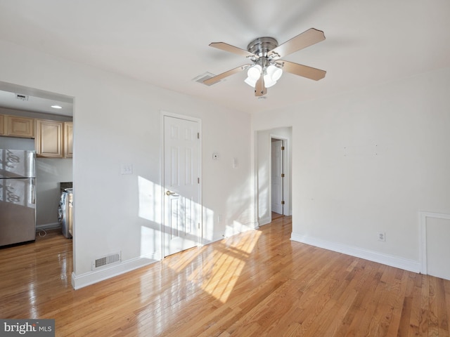 empty room with light hardwood / wood-style floors and ceiling fan