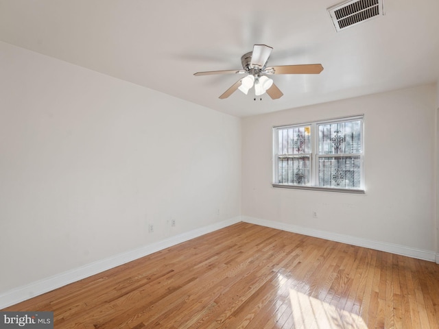 spare room with light wood-type flooring and ceiling fan