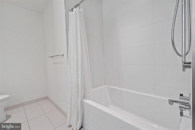 bathroom featuring tile patterned flooring, toilet, and shower / bathtub combination with curtain