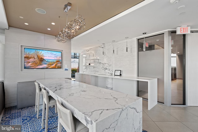 dining room featuring light tile patterned floors and a chandelier