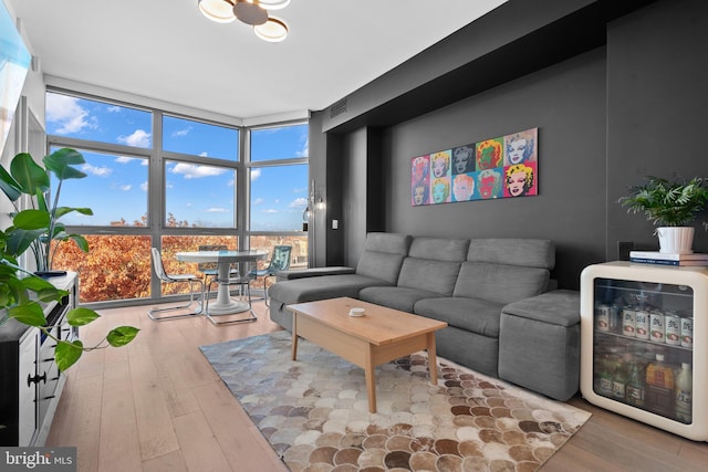 living room with expansive windows and hardwood / wood-style flooring