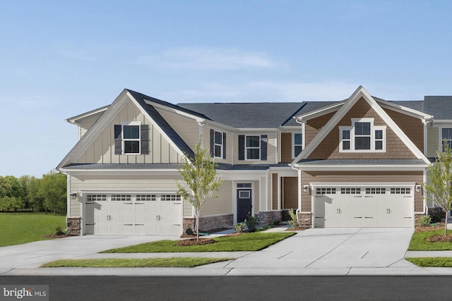 craftsman-style house with a front yard and a garage