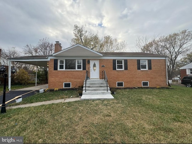 view of front of home featuring brick siding, a front lawn, a chimney, a carport, and driveway