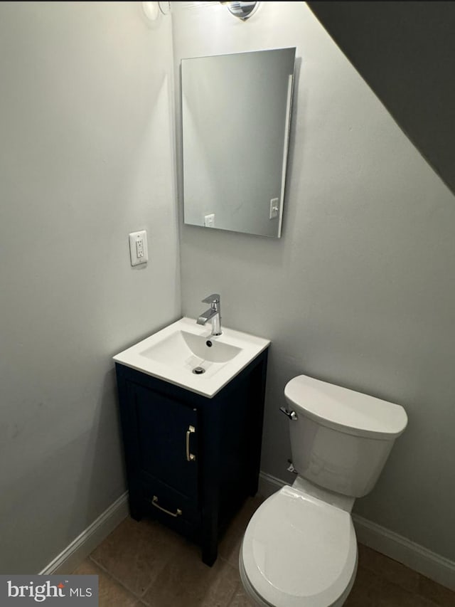 bathroom with tile patterned floors, vanity, and toilet