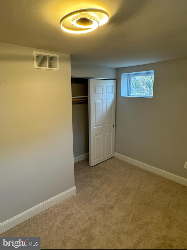 unfurnished bedroom featuring carpet and a closet