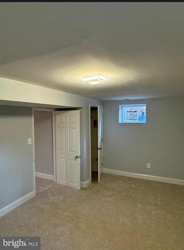 unfurnished bedroom with light carpet and a closet