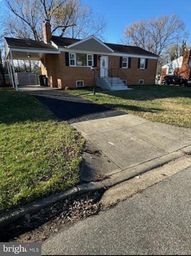 single story home featuring a front lawn and a carport