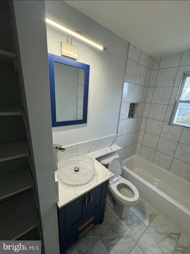 full bathroom featuring vanity, toilet, and tiled shower / bath combo