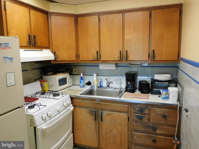 kitchen featuring tile walls, sink, extractor fan, and white appliances