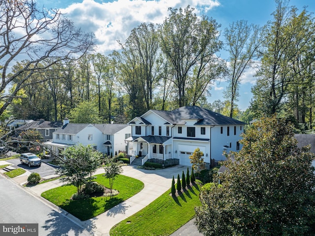 view of front of property featuring a front yard and a garage