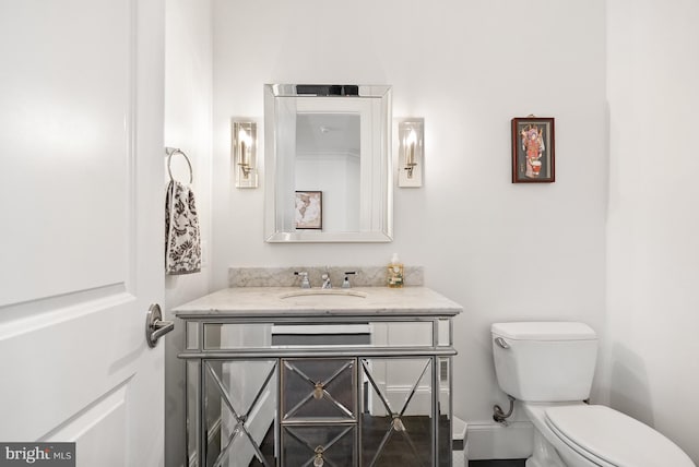 bathroom with toilet and vanity