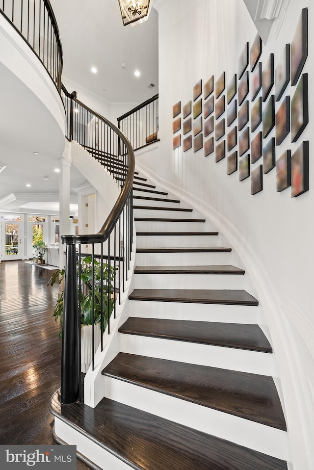 stairway featuring ornate columns and crown molding