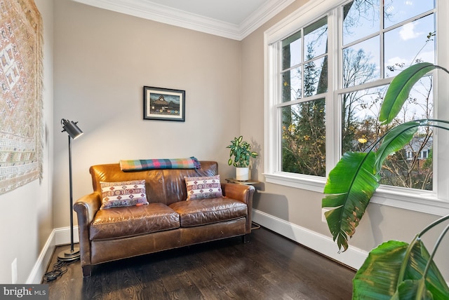 living area with dark wood-type flooring and ornamental molding