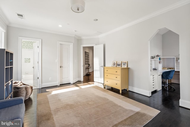 bedroom with ensuite bathroom, ornamental molding, and dark hardwood / wood-style flooring