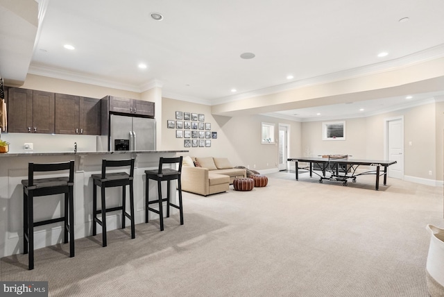 living room featuring ornamental molding and light colored carpet