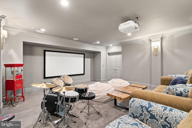 cinema room with crown molding and carpet floors