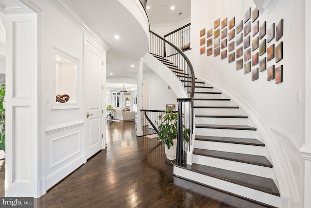 staircase featuring hardwood / wood-style flooring and ornamental molding